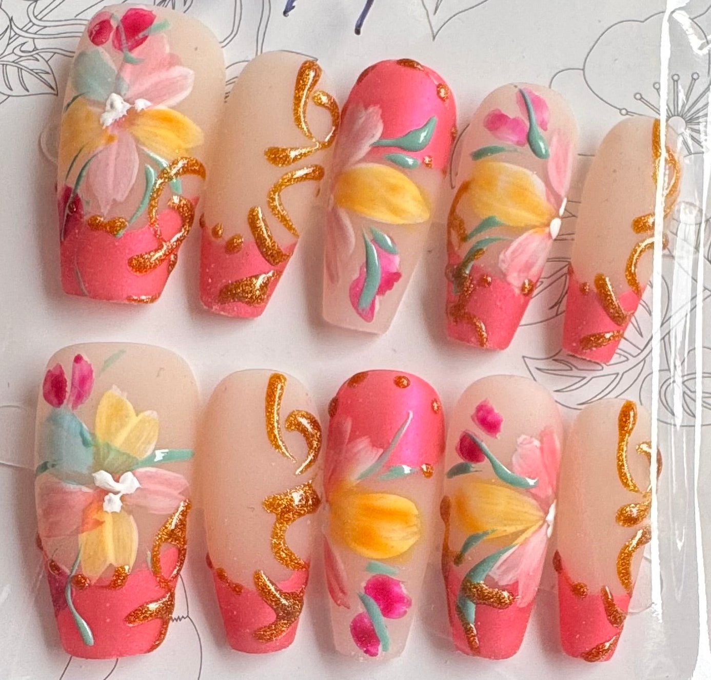 Set of colorful nail art designs in packaging on a wooden surface