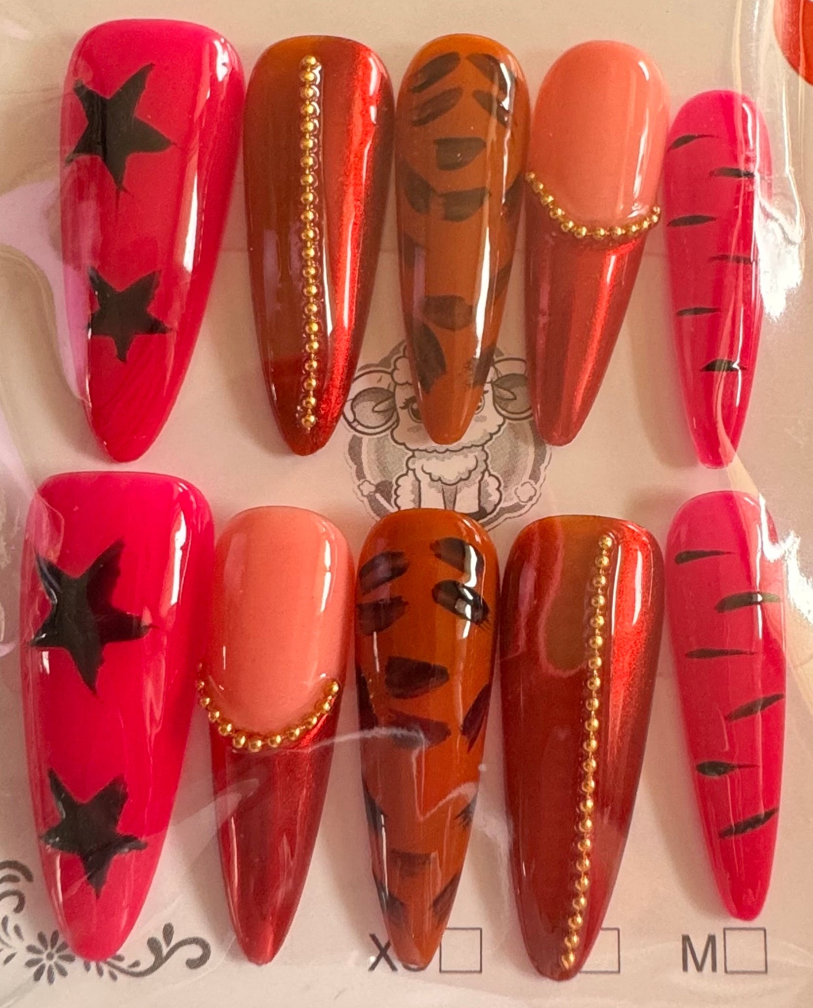 Packaged set of red and orange nail art designs on a white background
